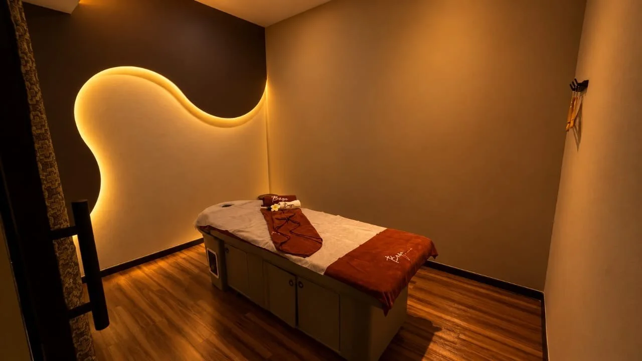A prepared massage bed beneath softly glowing curved walls